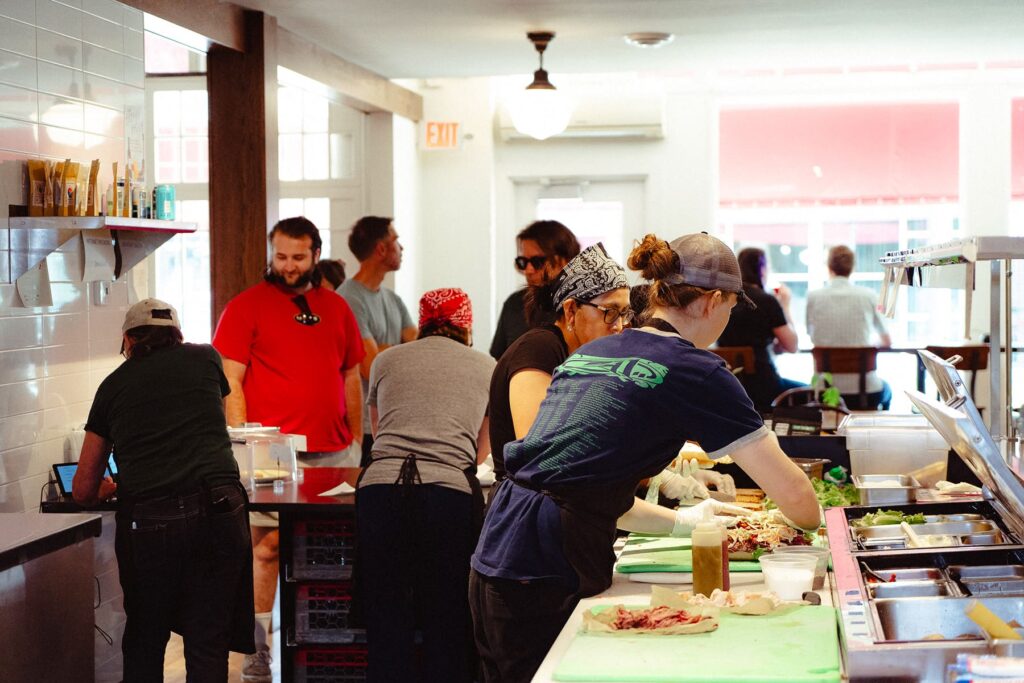 The bustling sandwich counter at a local butcher shop